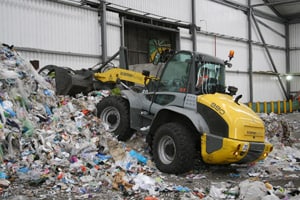 The loader is being used to handle dry recyclables